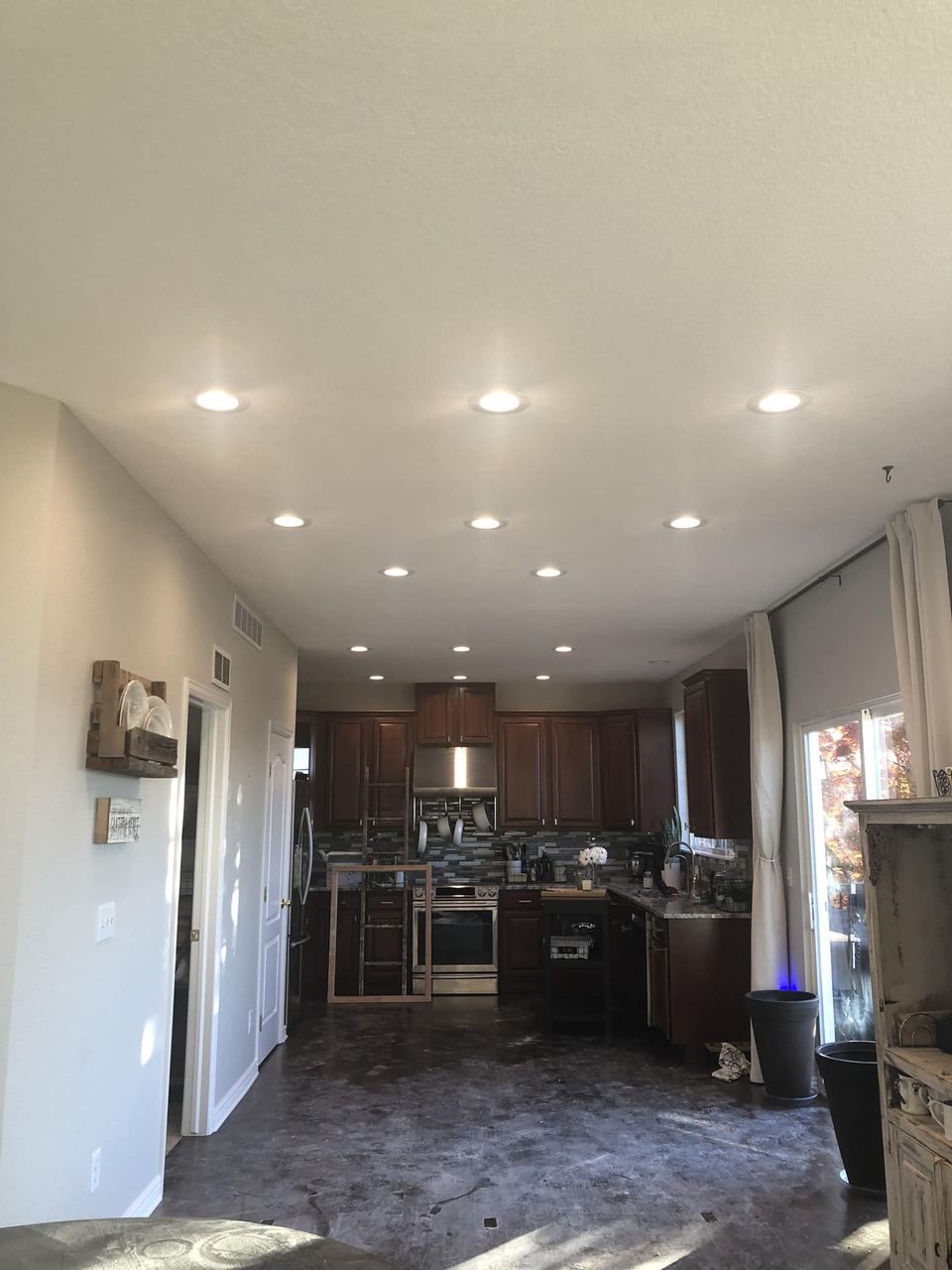 A kitchen with a lot of lights on the ceiling