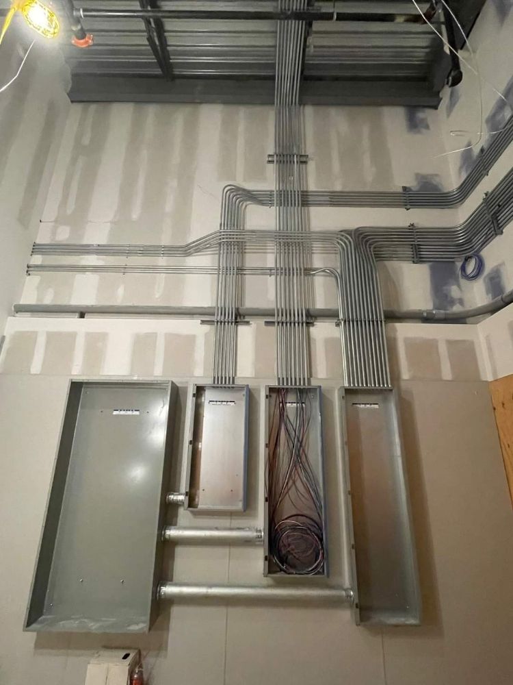 A room with a lot of electrical wires hanging from the ceiling.