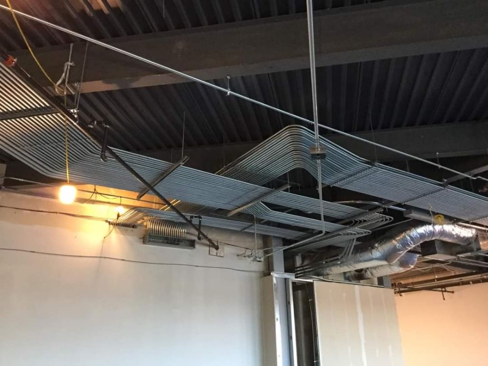 A ceiling with a lot of wires hanging from it