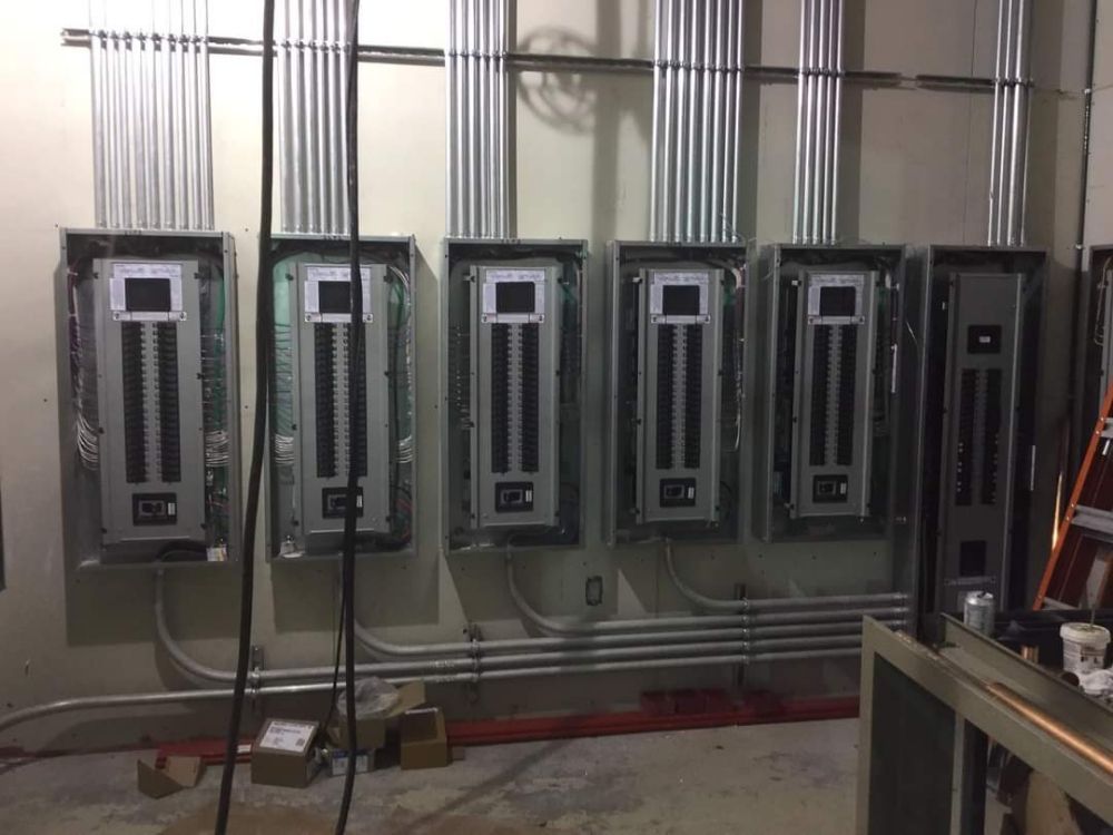 A room with a lot of electrical panels on the wall.