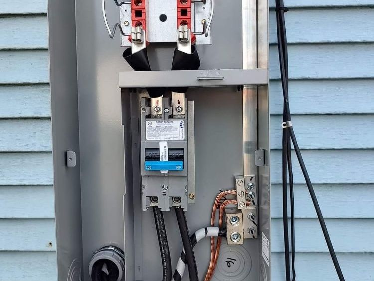 The inside of a electrical box on the side of a house.