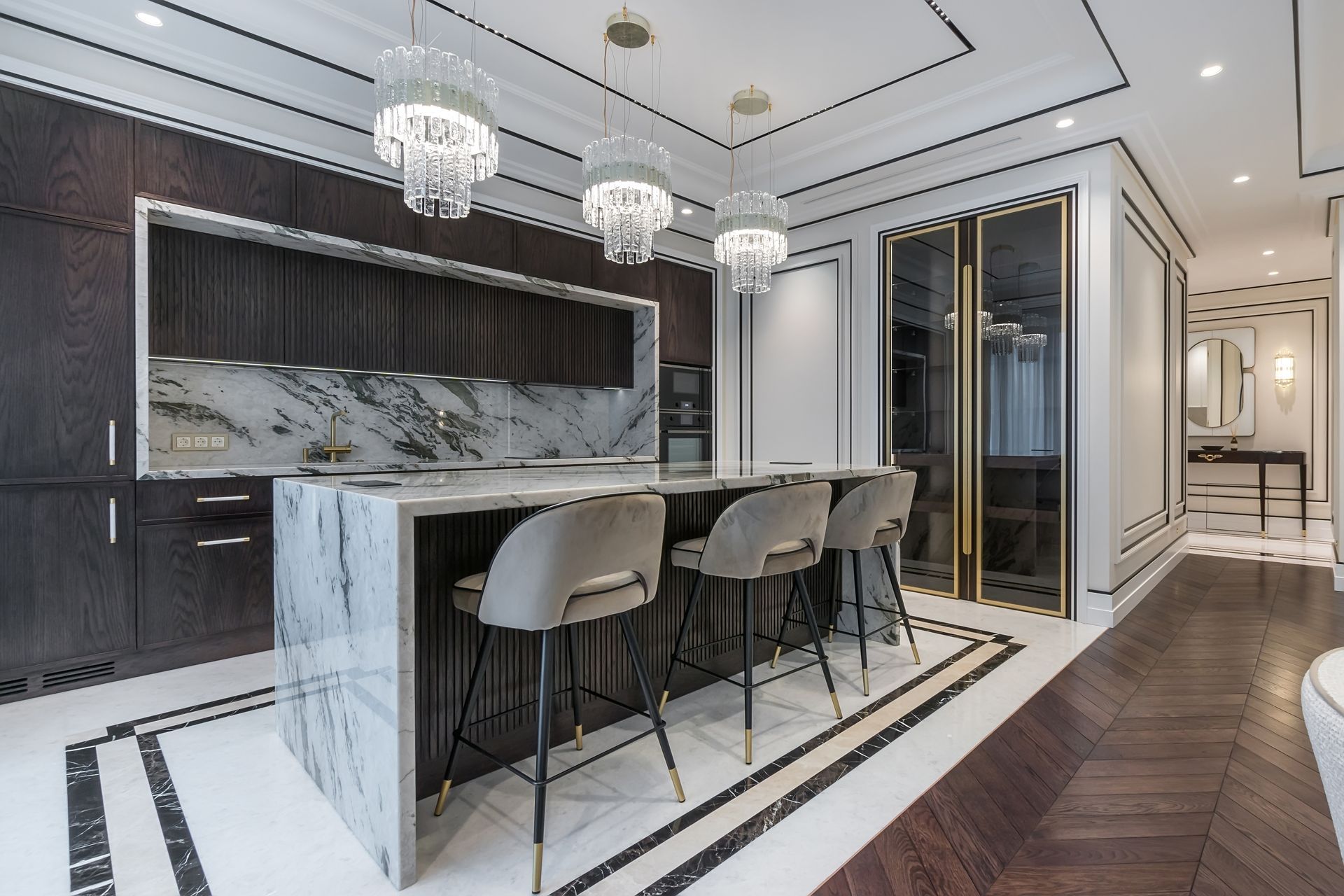 Luxury modern kitchen with marble island, pendant lights, and barstools