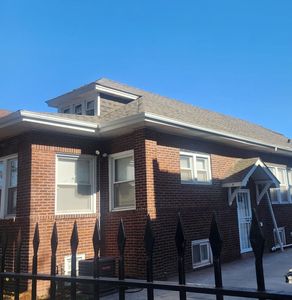 A brick house with a fence in front of it