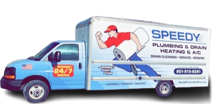 A man with a backpack is standing next to a lake in the woods.