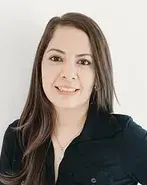 A man in a plaid shirt is standing with his arms crossed.