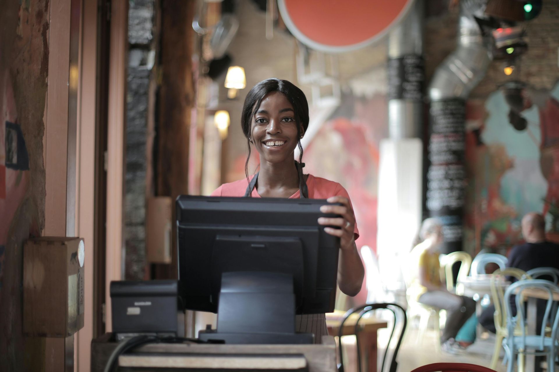 A man and a woman are looking at a clipboard.