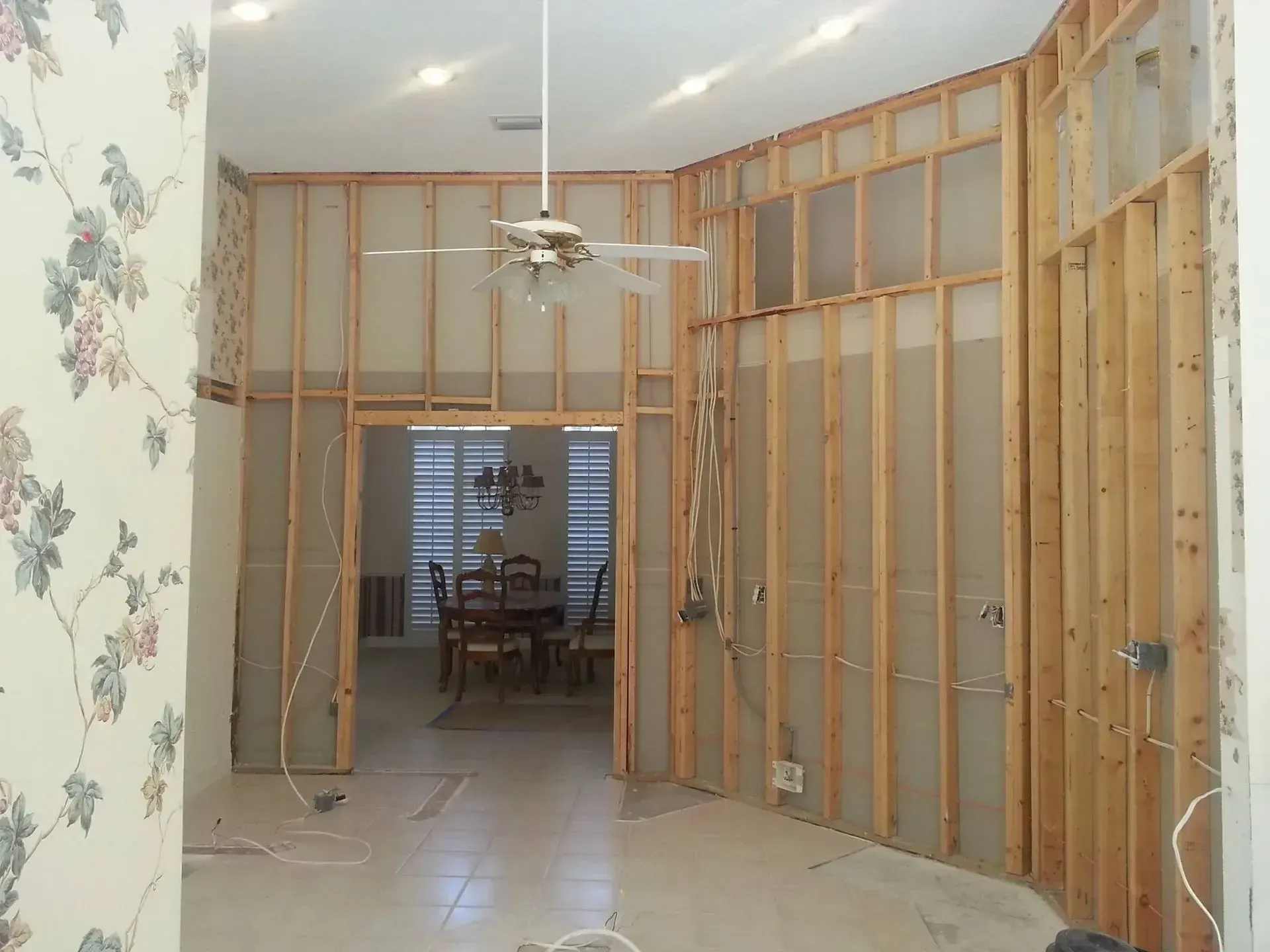 A room with wooden walls and a ceiling fan