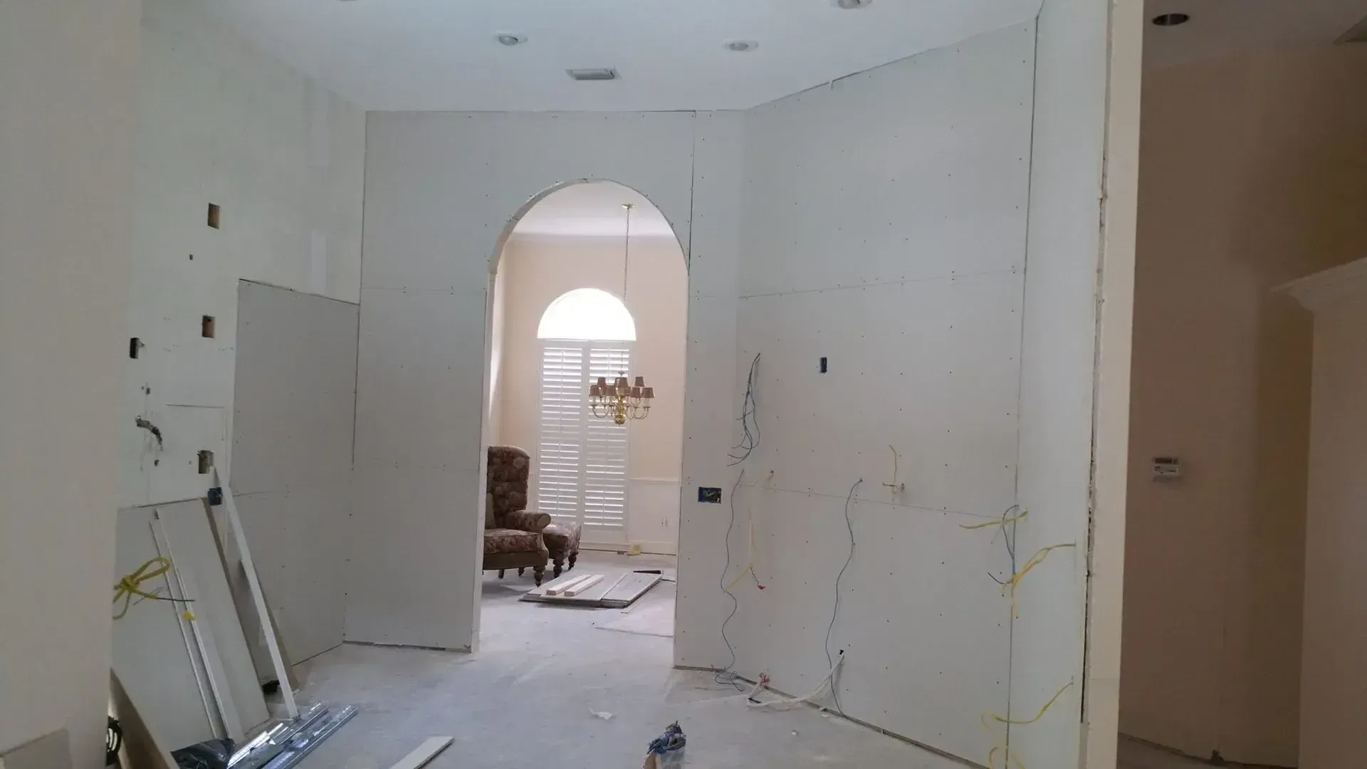 A room with white walls and a chair in it.