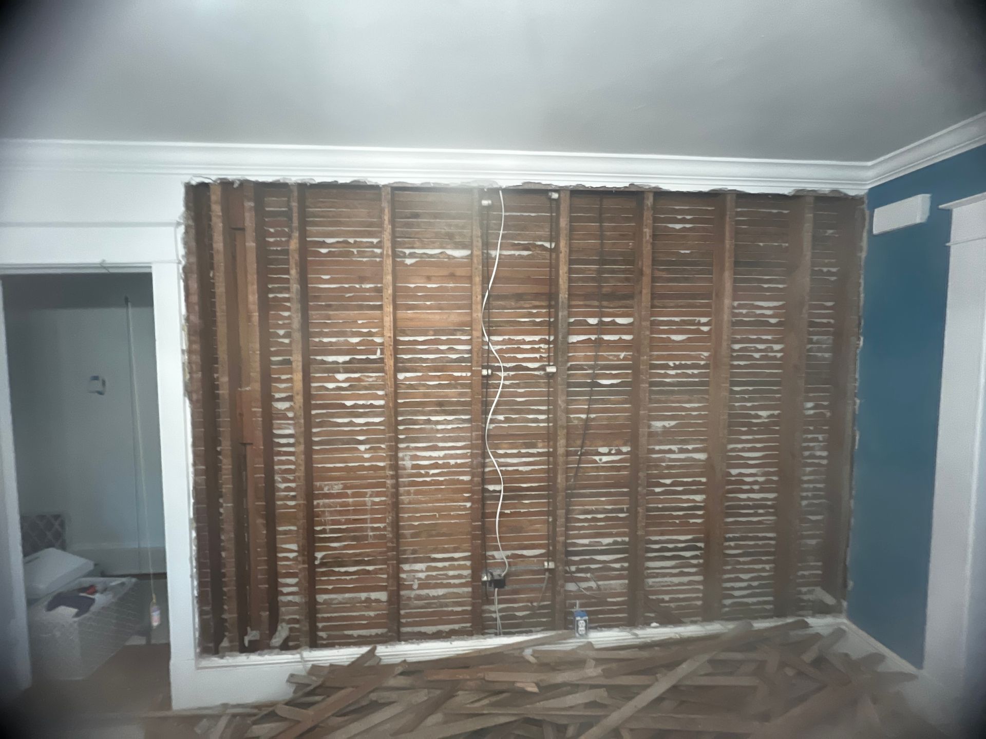 A room with a wooden wall that is being removed