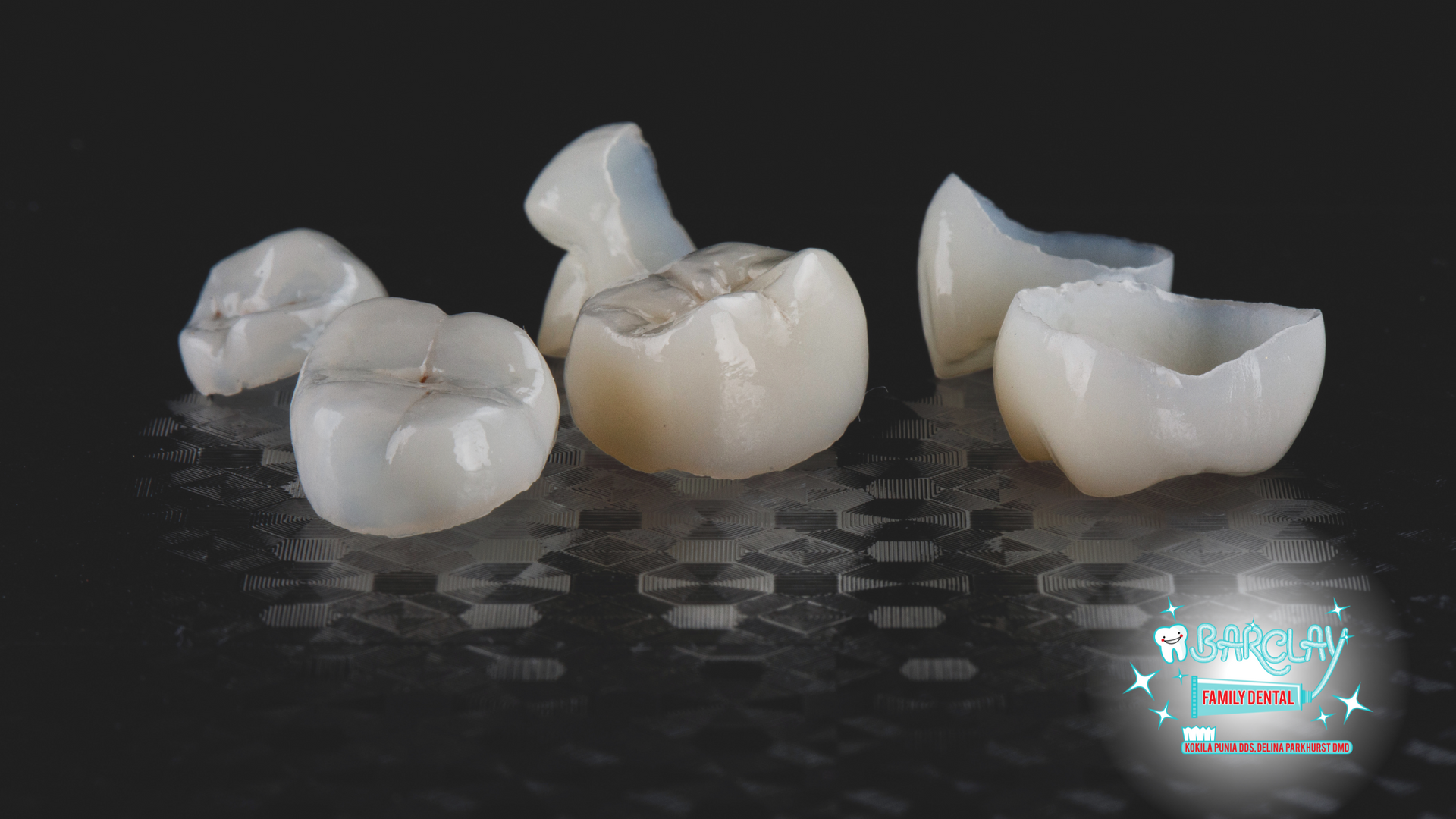 A group of dental crowns are sitting on a table.