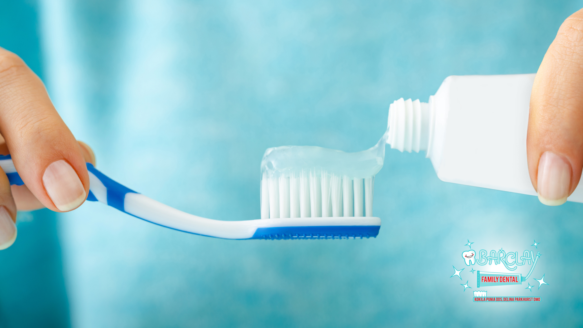 Person squeezing toothpaste onto a toothbrush; close-up view.