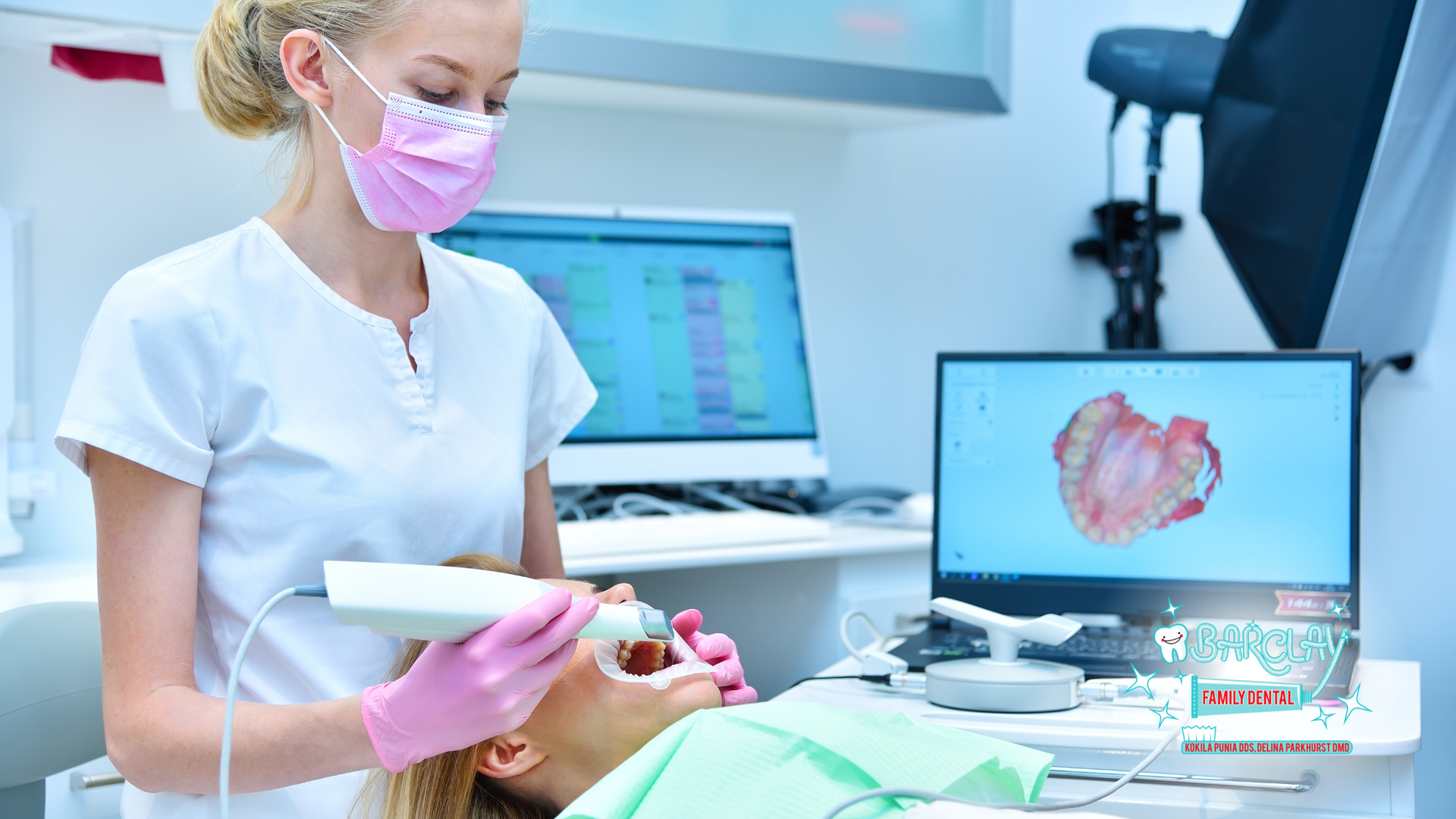 A female dentist is taking a picture of a patient 's teeth.