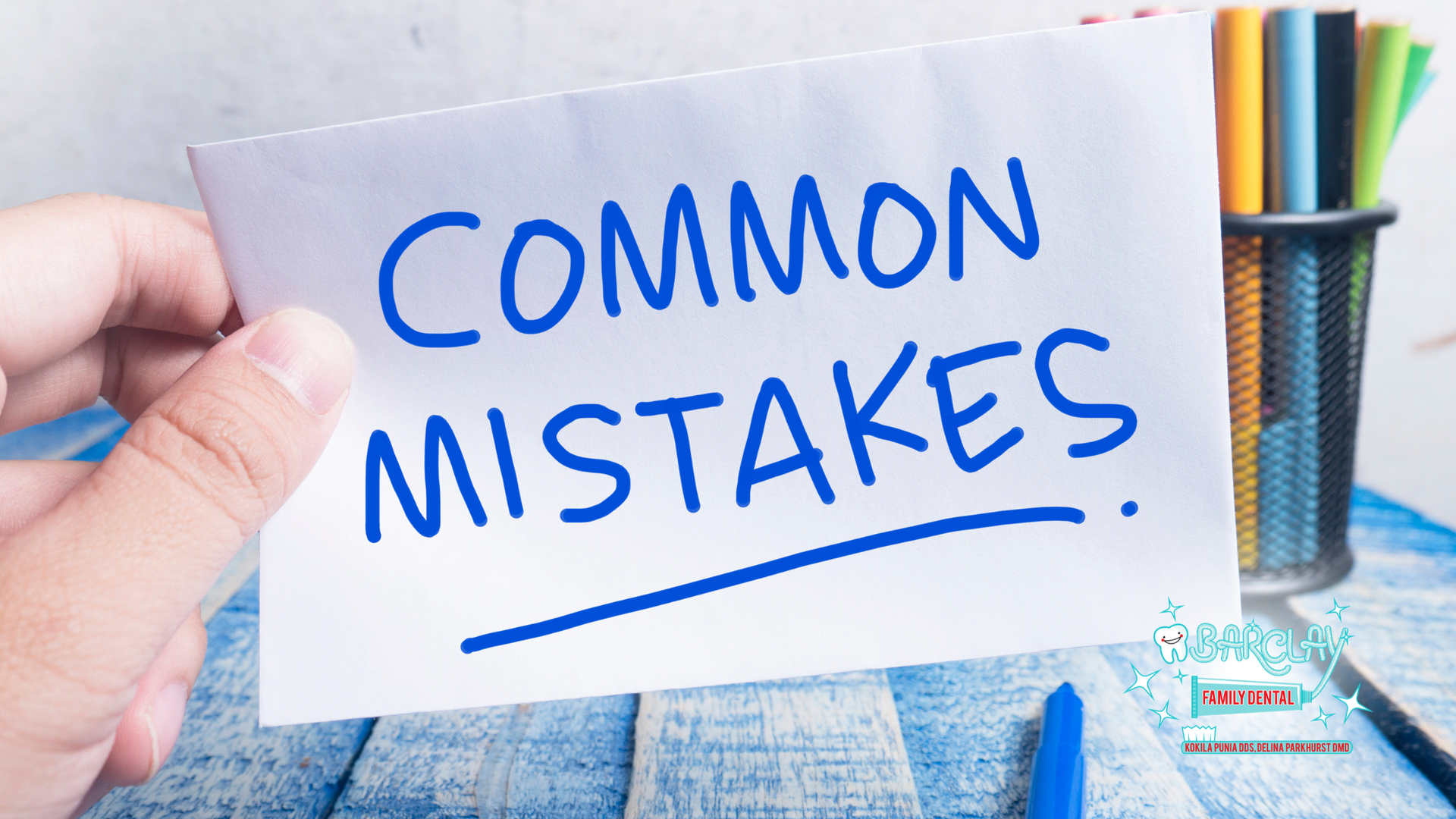 A person is holding a piece of paper that says `` common mistakes ''.