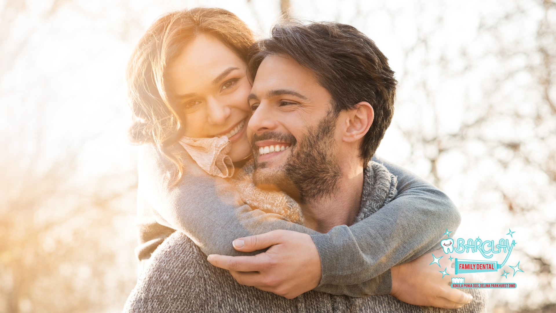 Woman hugging a smiling man outdoors, sunlight, warm tones.