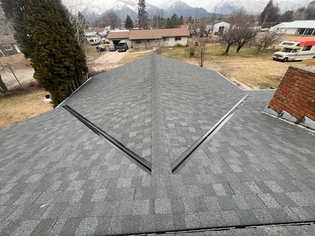 A large brown house with a black roof