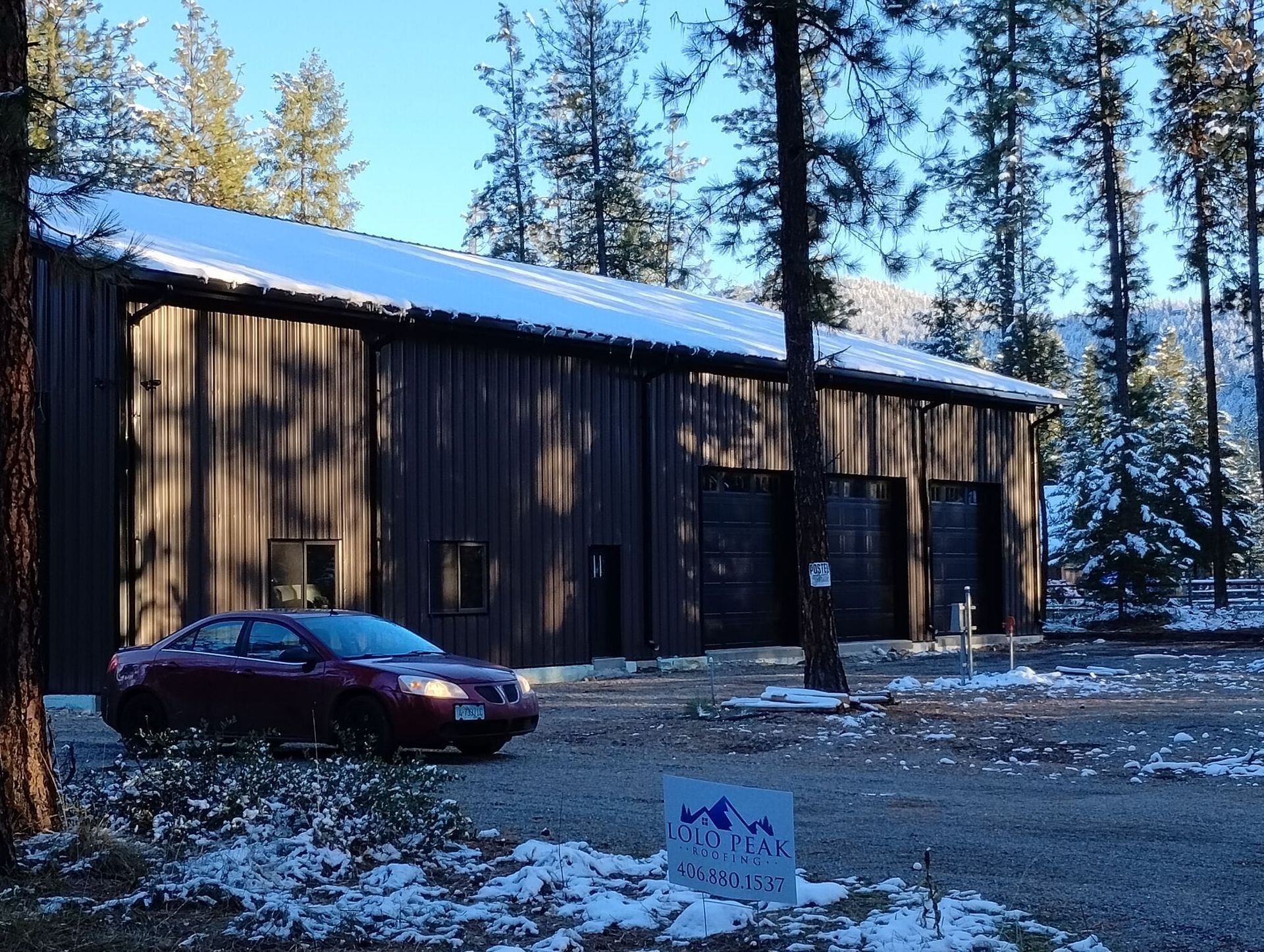 A red car is parked in front of a building