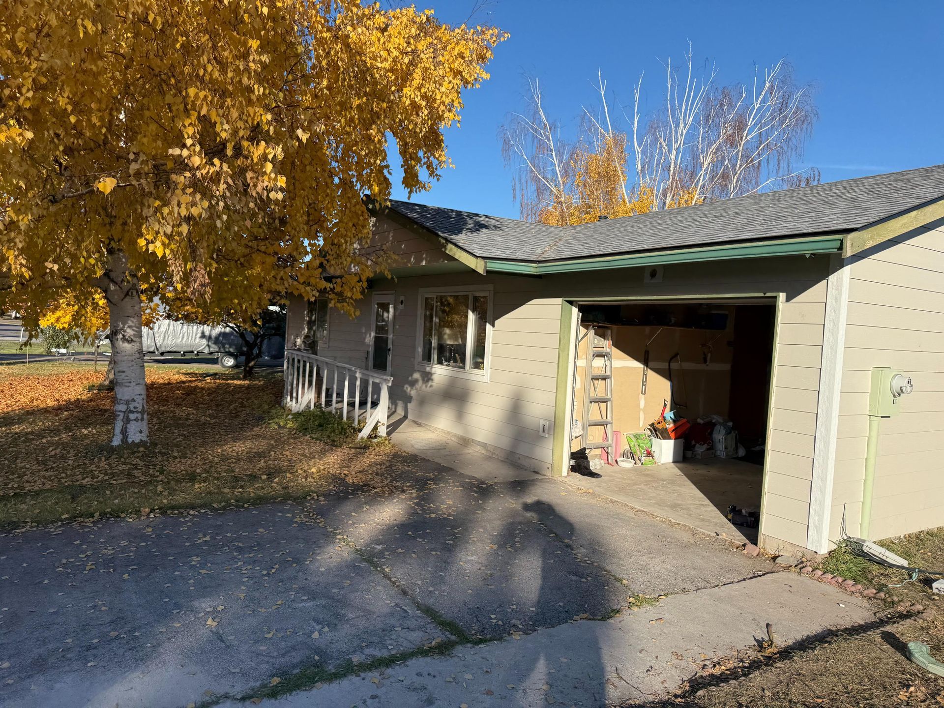 A red car is parked in front of a building