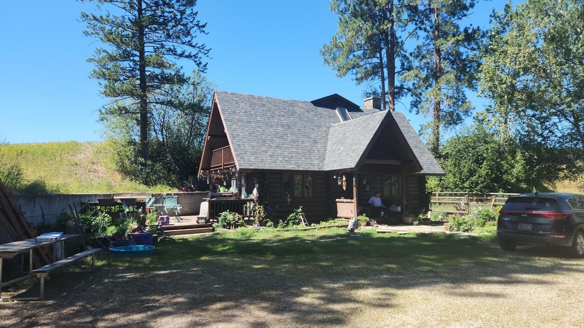 A house with a brown roof and white trim