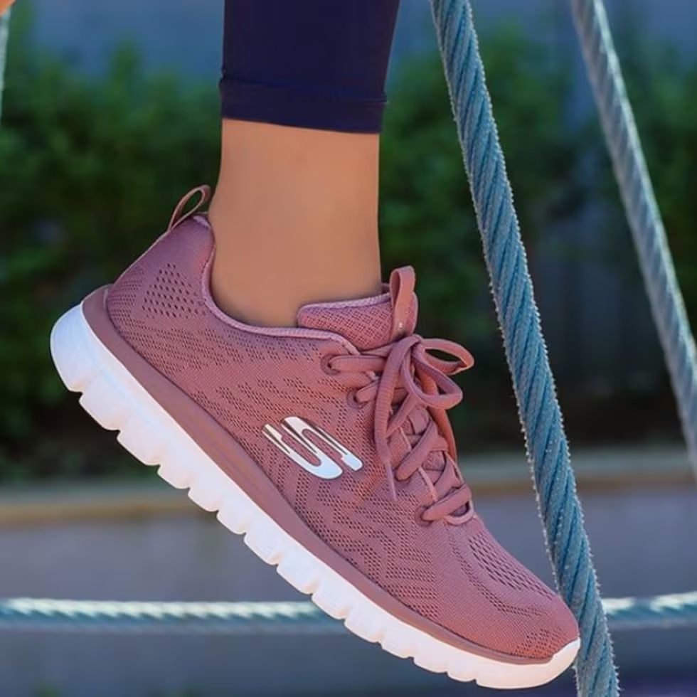 Zapatilla deportiva Skechers rosa con suela blanca.