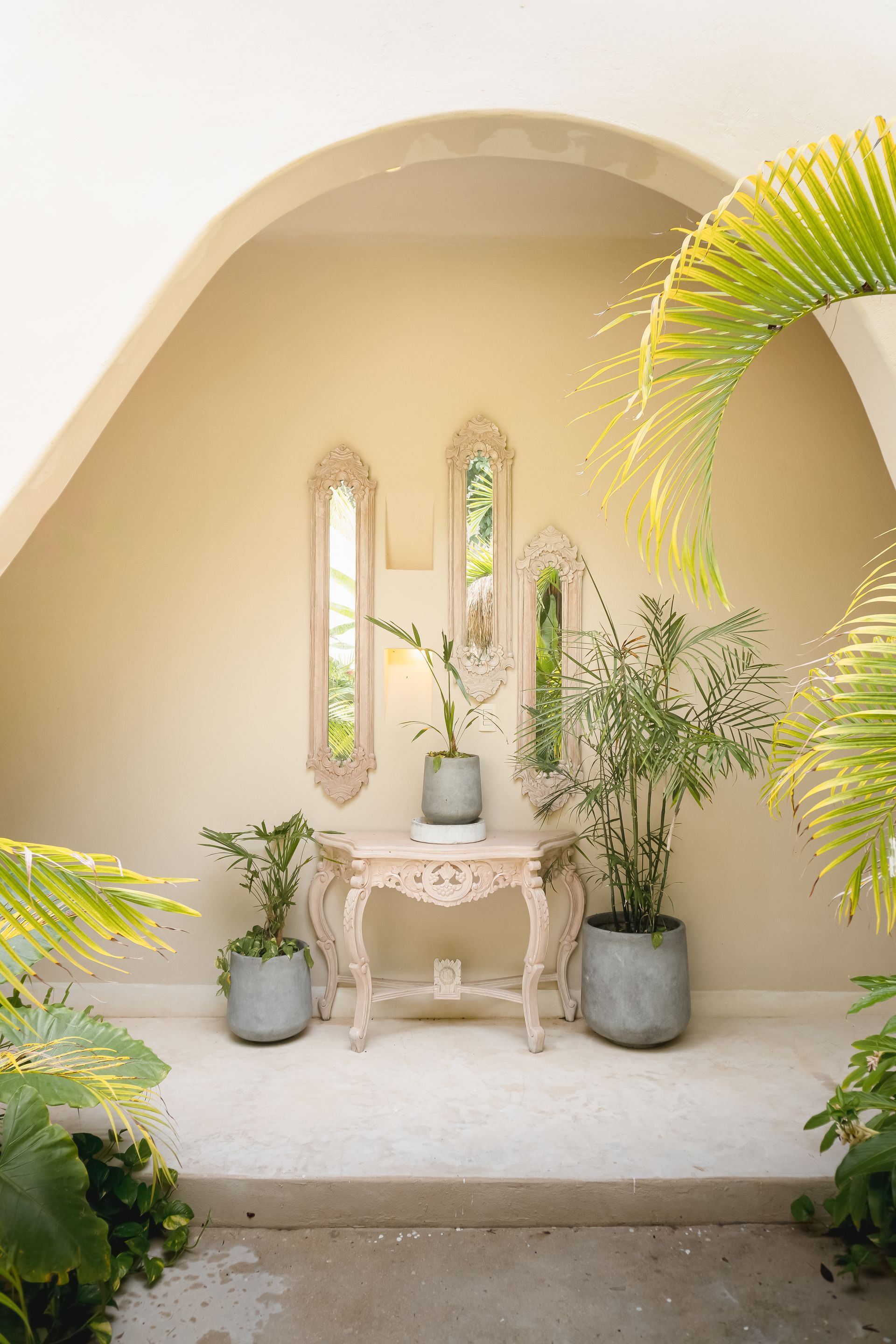 Lush green tropical landscape with buildings featuring thatched roofs and wooden structures.