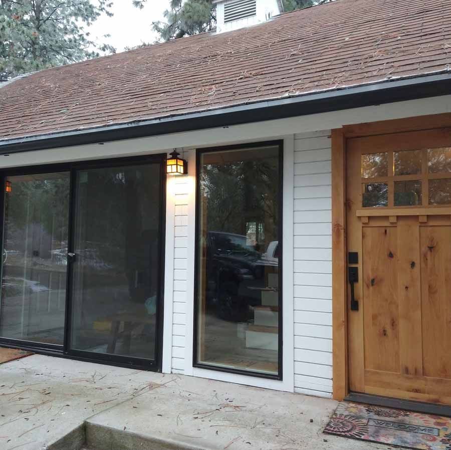 A house with a wooden door and sliding glass doors