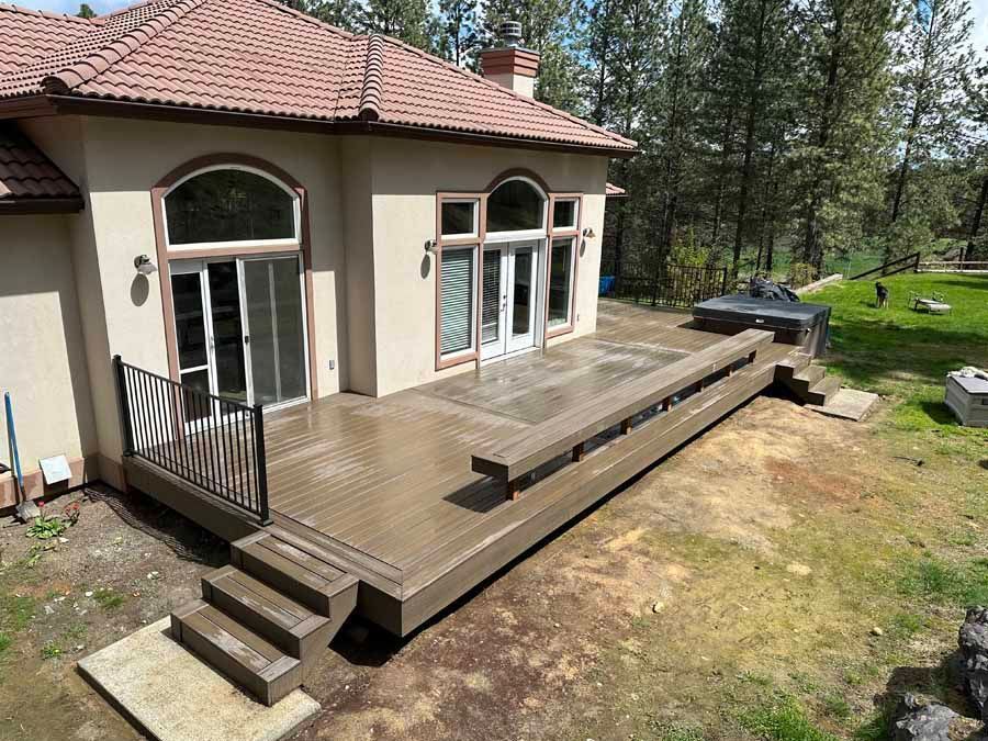A large house with a large deck in front of it.
