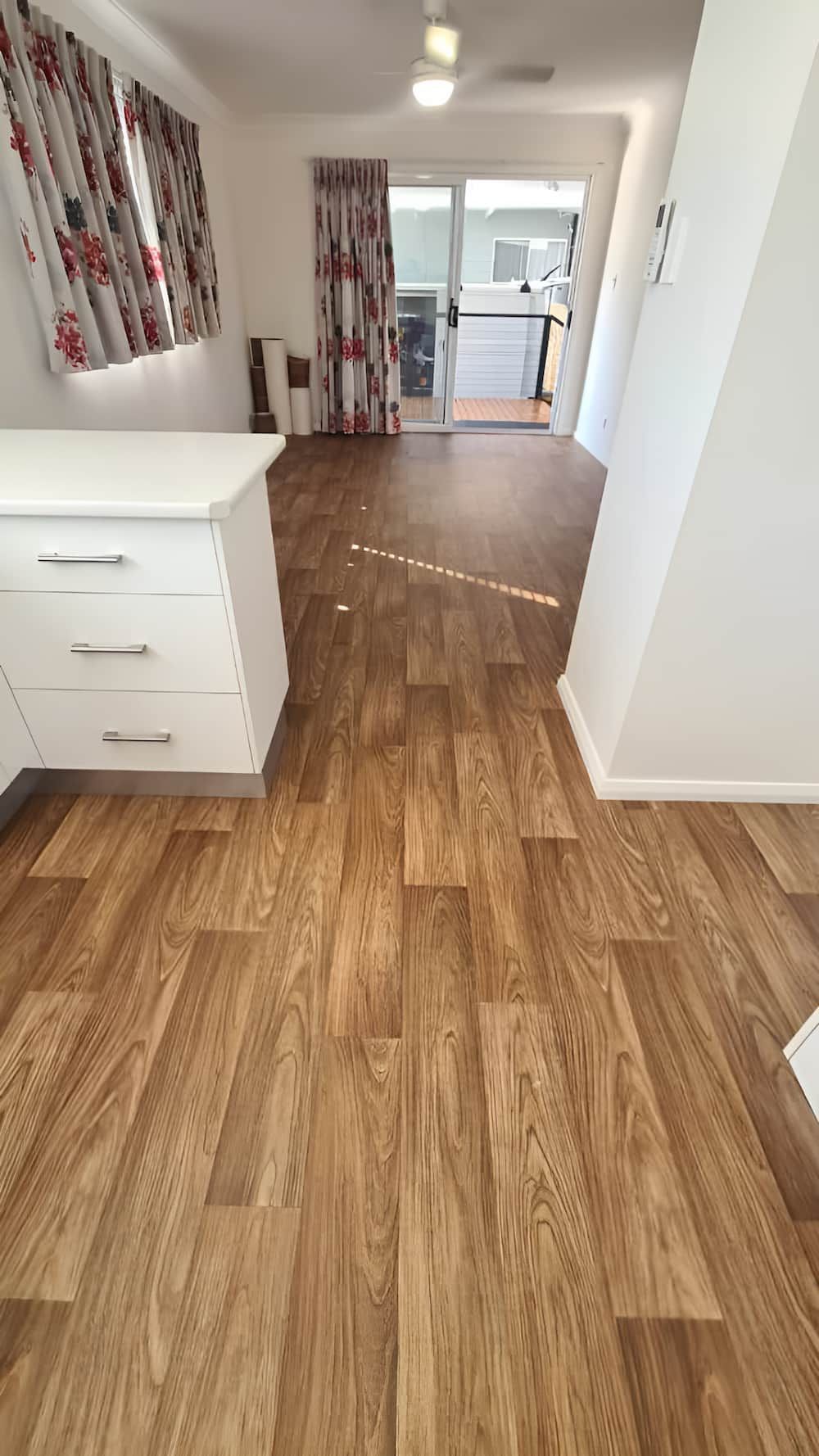 A Room With A Wooden Floor And A White Cabinet — Charmhaven Carpets In Charmhaven, NSW