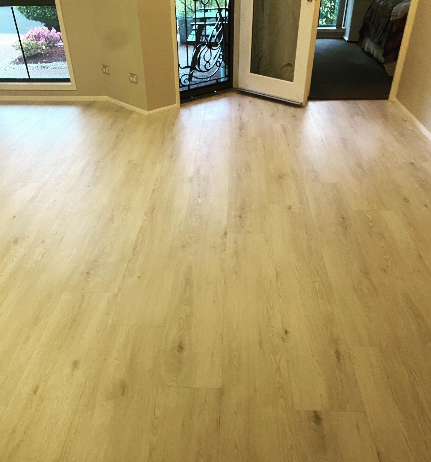 A Room With a Wooden Floor and a Sliding Glass Door — Charmhaven Carpets In Charmhaven, NSW