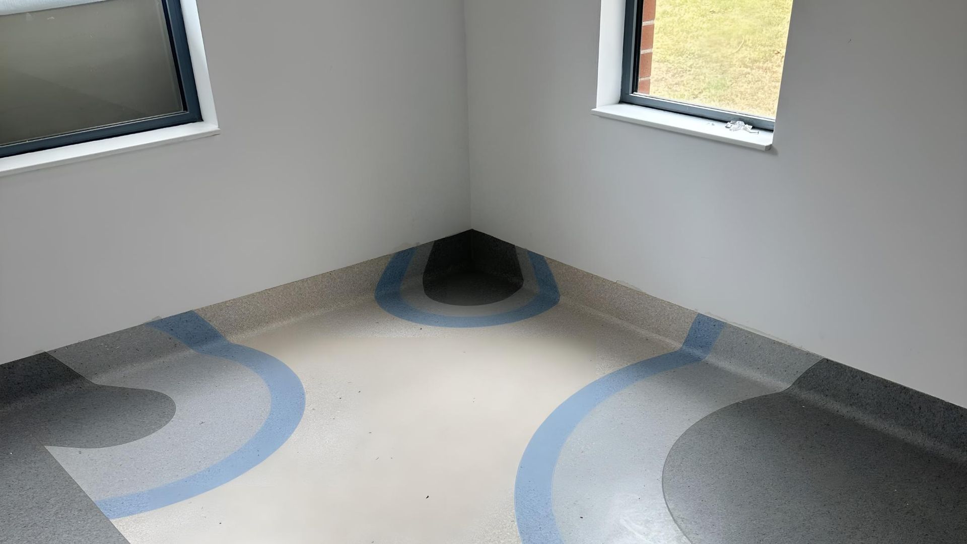 A Corner of a Room With Circles on the Floor and Two Windows — Charmhaven Carpets In Charmhaven, NSW