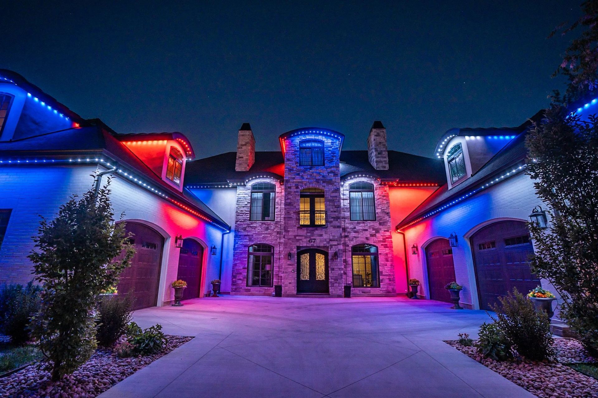 White doorbell camera on a brown door, near a black doorknob and lock.