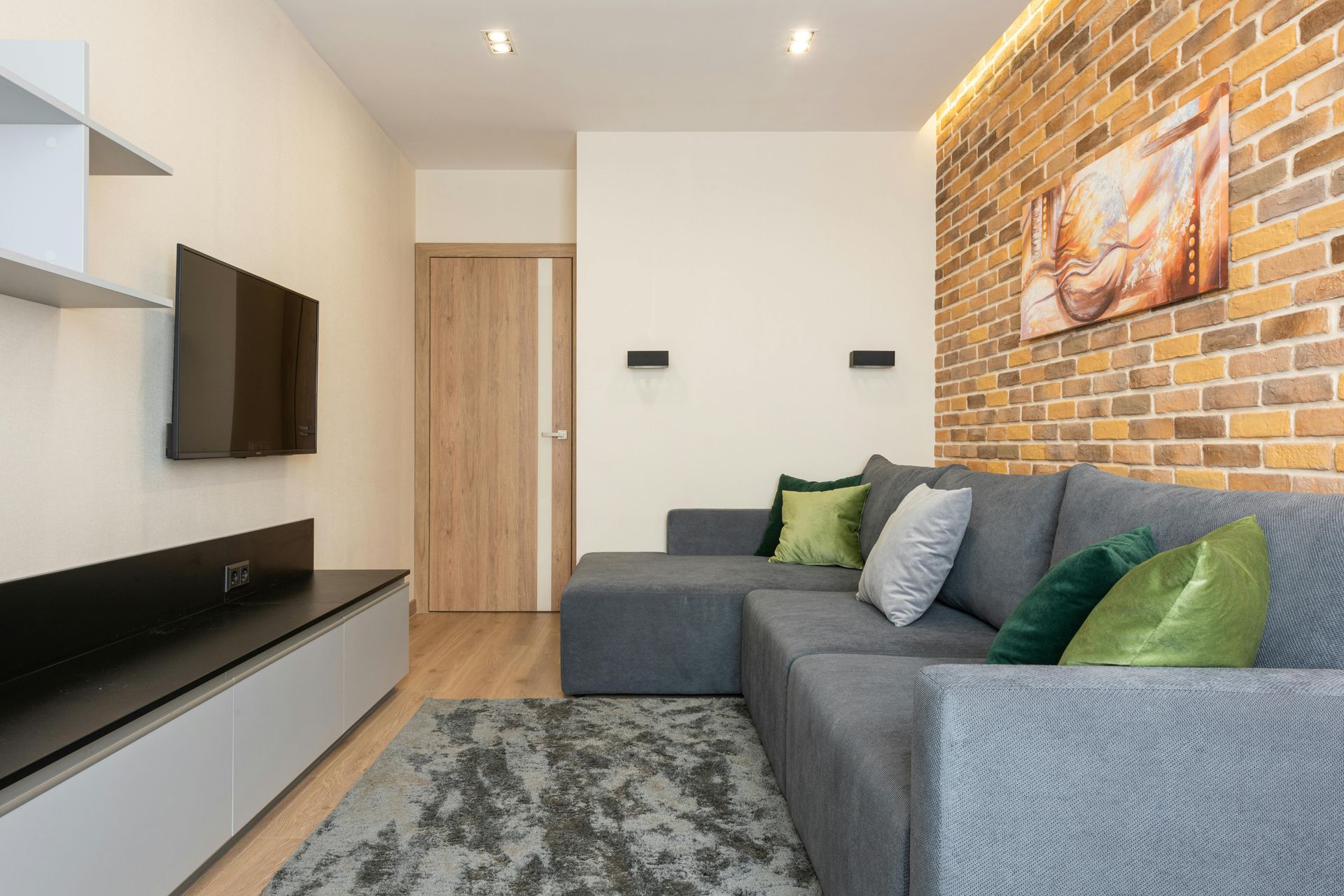 White doorbell camera on a brown door, near a black doorknob and lock.