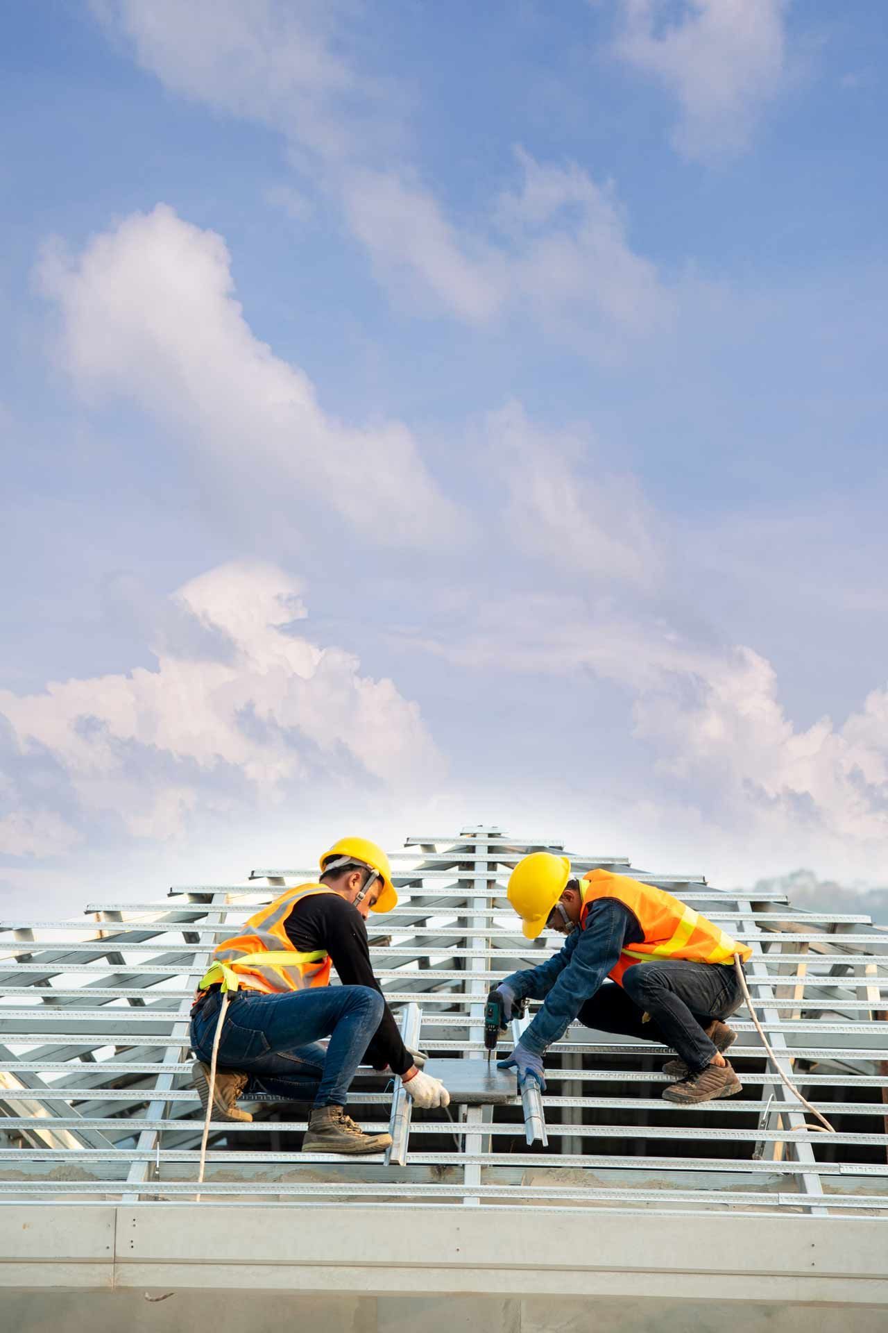 Workers on installing metal roof