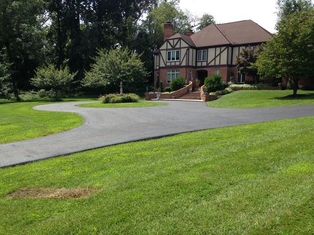 A large house with a driveway leading to it