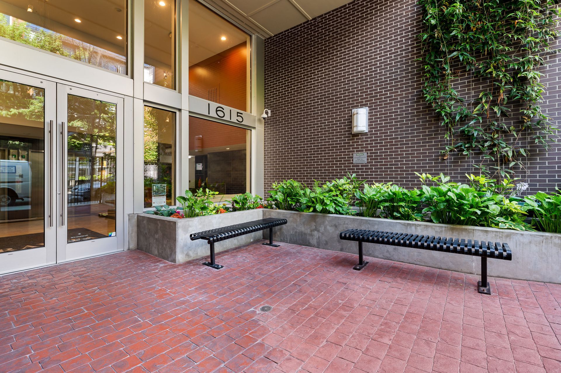 Photo of the entrance, featuring outdoor seating