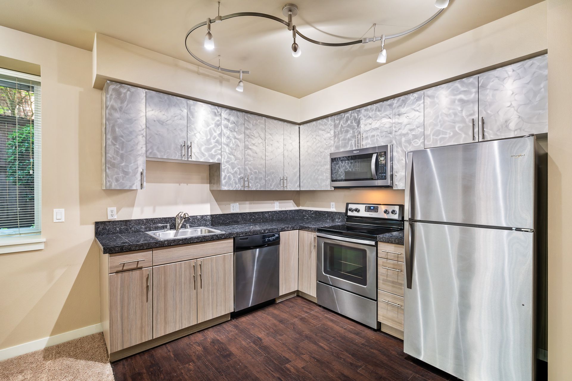 Photo of the kitchen featuring plenty of lighting
