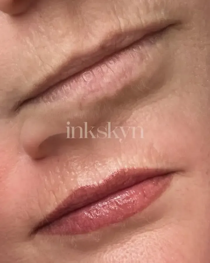A close up of a woman 's lips before and after permanent makeup.