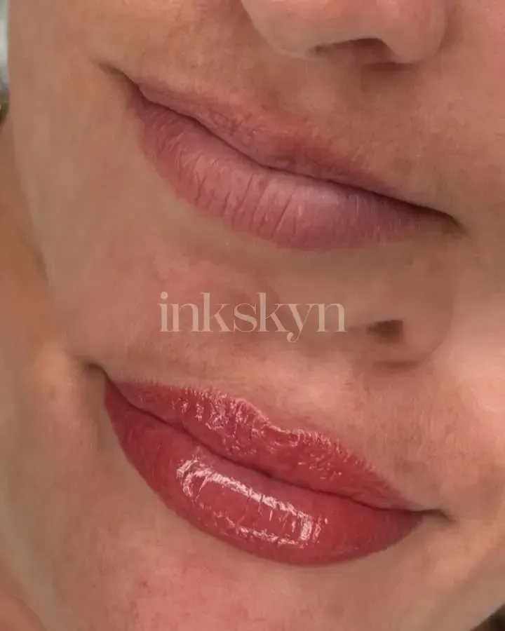 A close up of a woman 's lips with red lipstick.