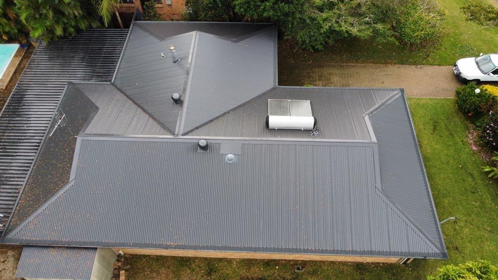 Roof of a house in Port Macquarie with a solar hot water panel on it 