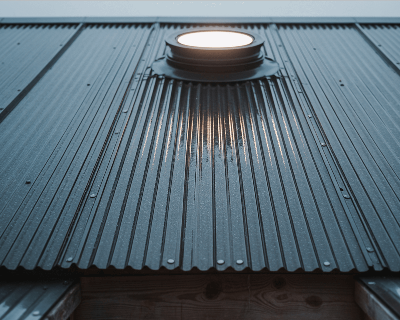 Red metal Roof of a house in Port Macquarie with a solar panels on it.