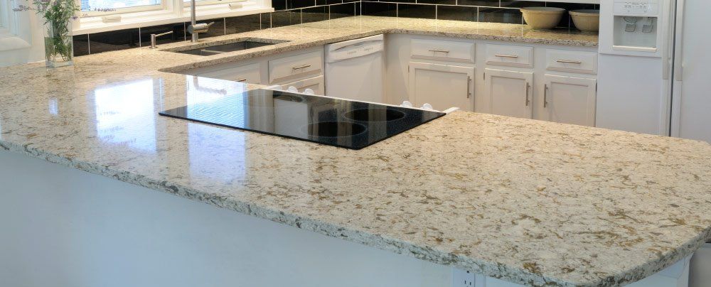 A kitchen with granite counter tops and a stove top oven.