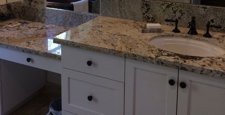 A bathroom with two sinks and a mirror.