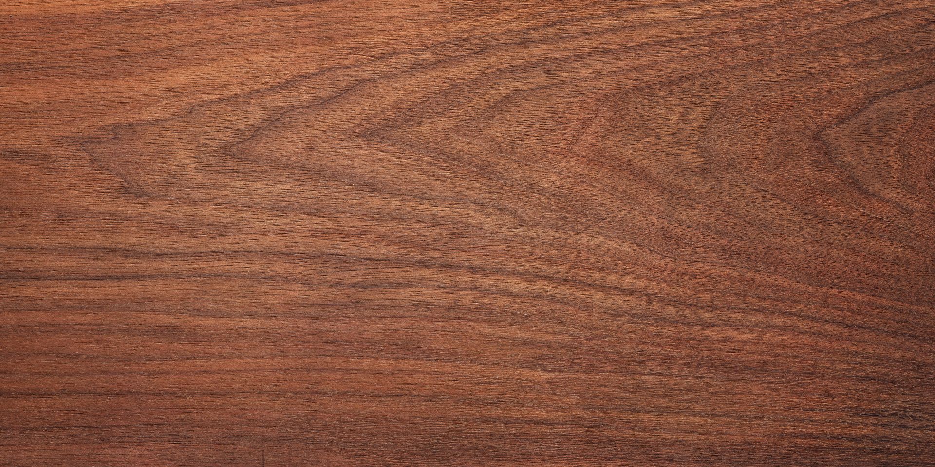 Close-up of brown wood grain with varying tones and patterns.