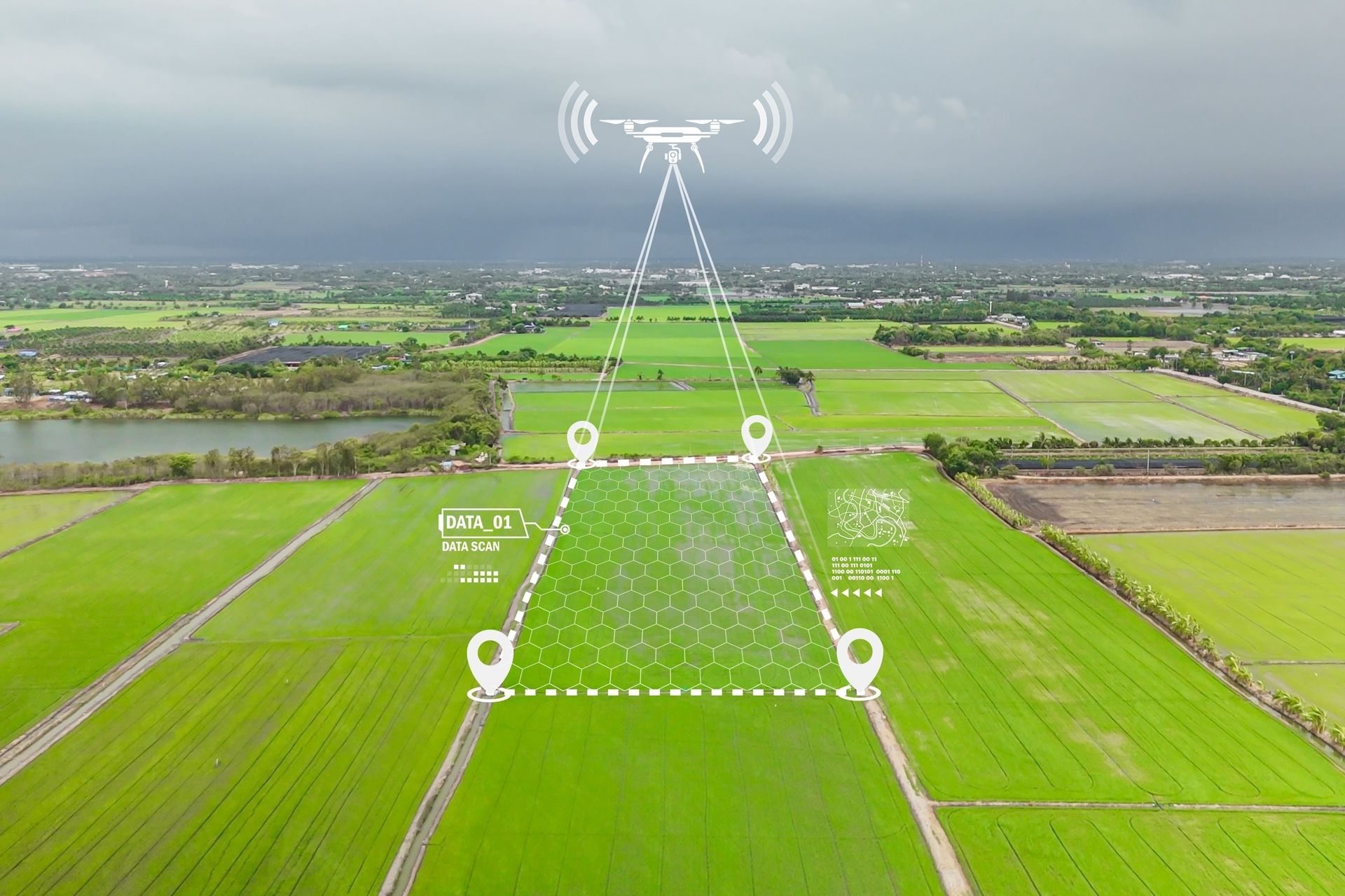 An aerial view of a drone flying over a green field.
