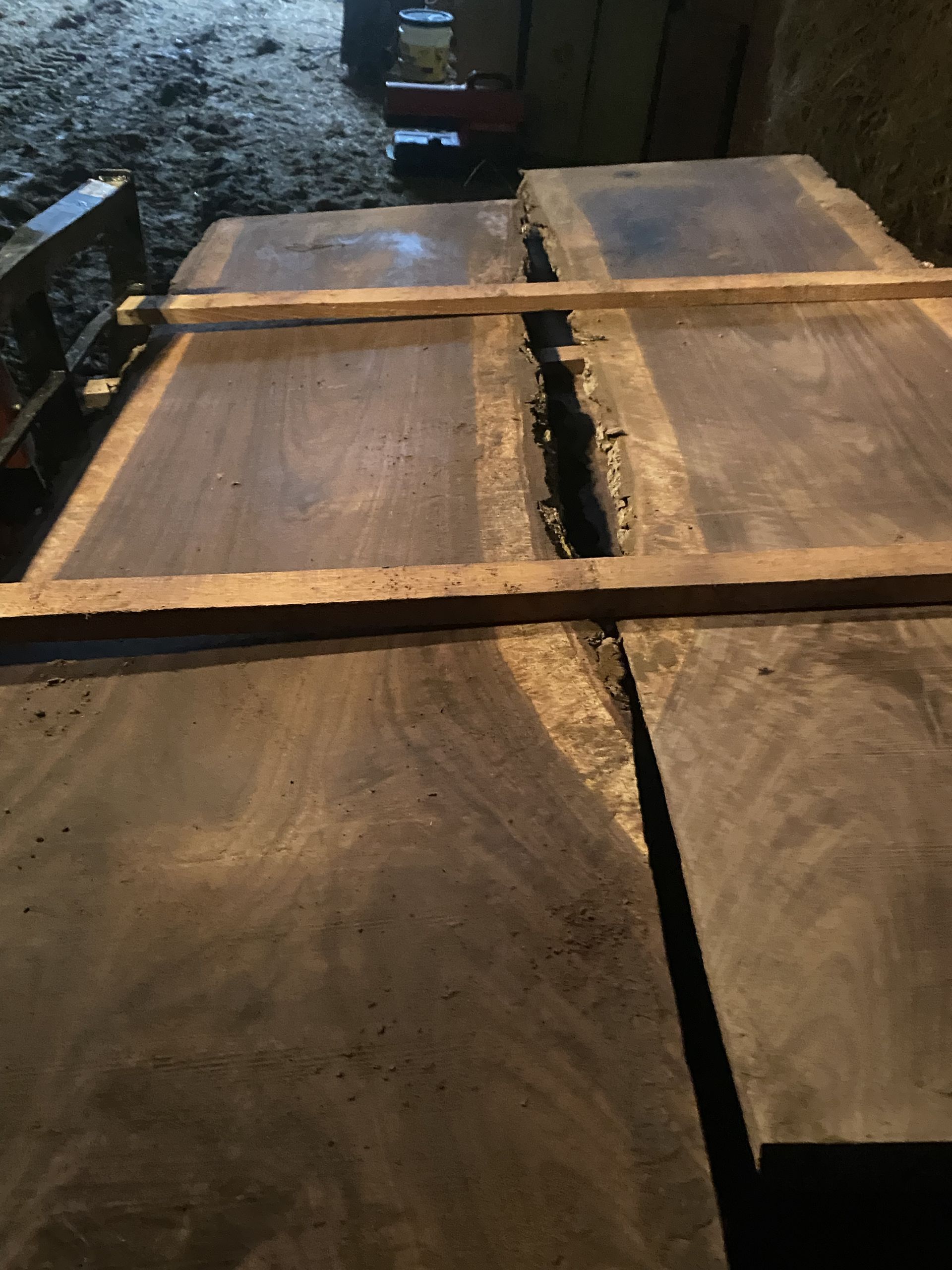 Wooden slabs with a gap, held together by wooden supports, indoors.