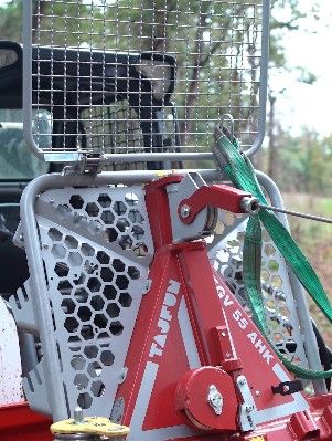 Close-up of a red Tajfun GV 55 AHK logging winch attached to a tractor.
