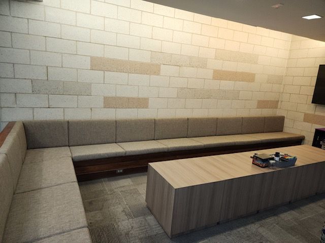 A living room with a long couch and a table