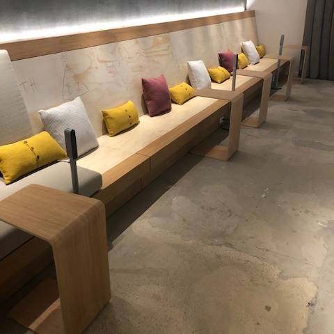 A row of couches with pillows on them in a room