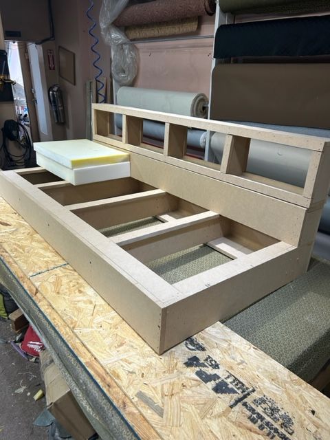 A wooden frame is sitting on top of a wooden table.