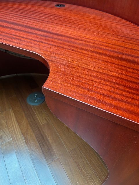 A conference room with a long table and red chairs