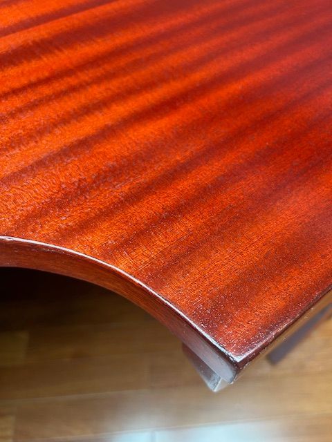 A conference room with a long table and red chairs